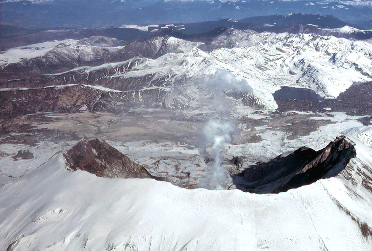 Mount St. Helens in winter, 1980–81, looking due north with Spirit Lake at right. The lake’s level was 60 m (200 ft) higher than before the eruption of May 18. The lake was dammed by the debris avalanche that flowed north before most of it turned down the North Fork Toutle River. (Kevin Scott photo)